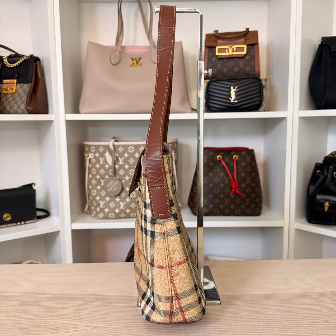 Luxe Vault Burberry House Check medium tote bag in dark brown leather and beige canvas, side view on display stand.