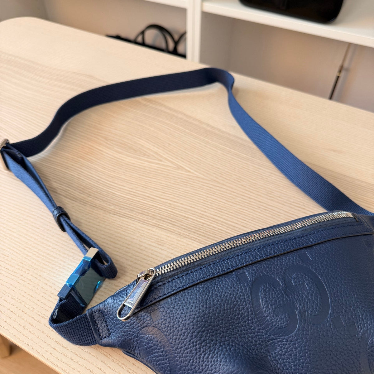 Luxe Vault Gucci belt bag in blue embossed leather with Jumbo GG pattern and adjustable strap with buckle