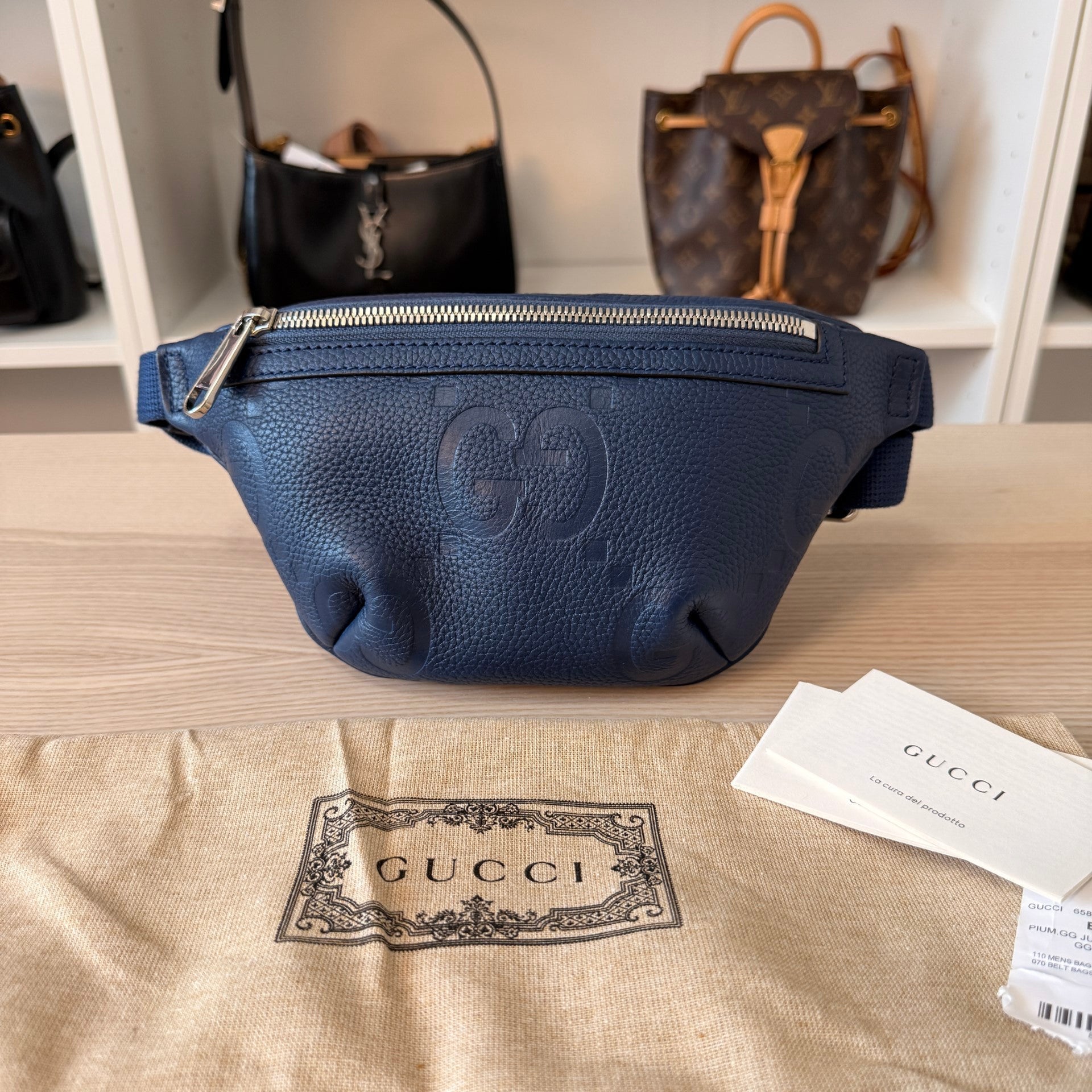 Luxe Vault blue Gucci Jumbo GG embossed leather belt bag with silver hardware, shown with dustbag and tags.