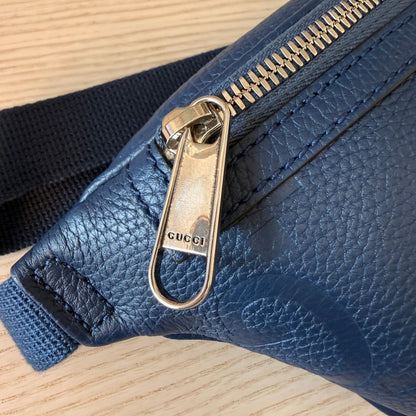Luxe Vault Gucci blue embossed leather belt bag featuring a silver metal zipper pull with engraved logo detail