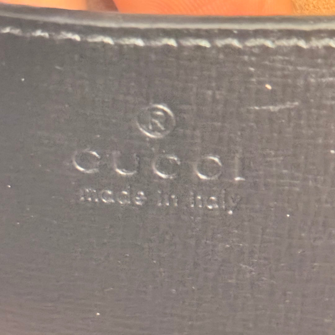 Luxe Vault Gucci logo embossed on black leather interior of a Monochrome Horsebit 1955 shoulder bag