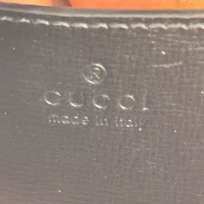 Luxe Vault Gucci logo embossed on black leather interior of a Monochrome Horsebit 1955 shoulder bag