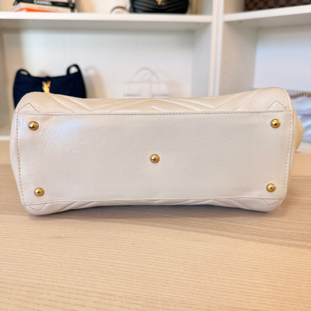 Luxe Vault Gucci white matelasse calfskin GG Marmont tote bag base with gold protective feet