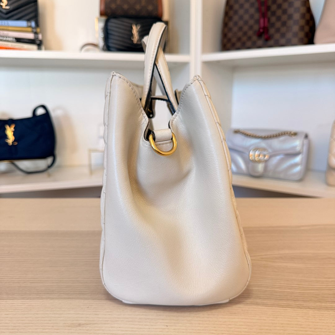 Luxe Vault white Gucci GG Marmont small matelasse calfskin tote bag side view with gold hardware