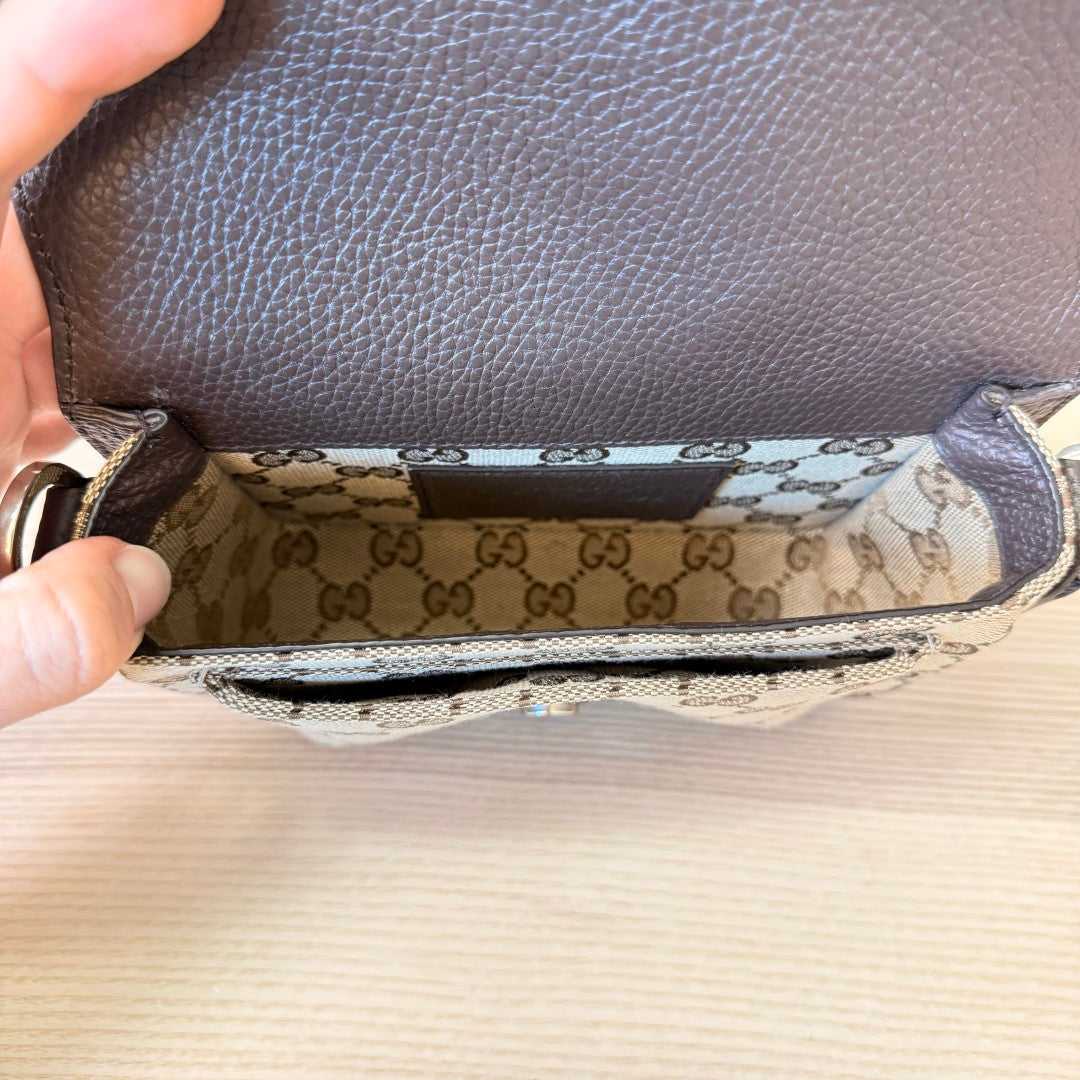 Luxe Vault Gucci monogram mini crossbody bag interior showing beige canvas lining and brown leather flap detail