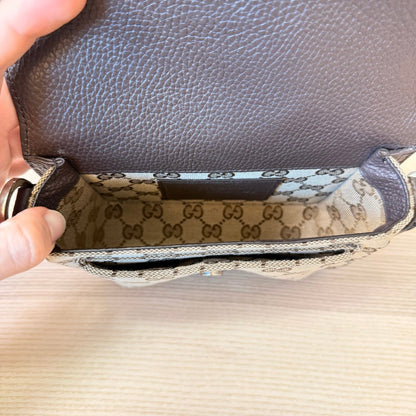 Luxe Vault Gucci monogram mini crossbody bag interior showing beige canvas lining and brown leather flap detail