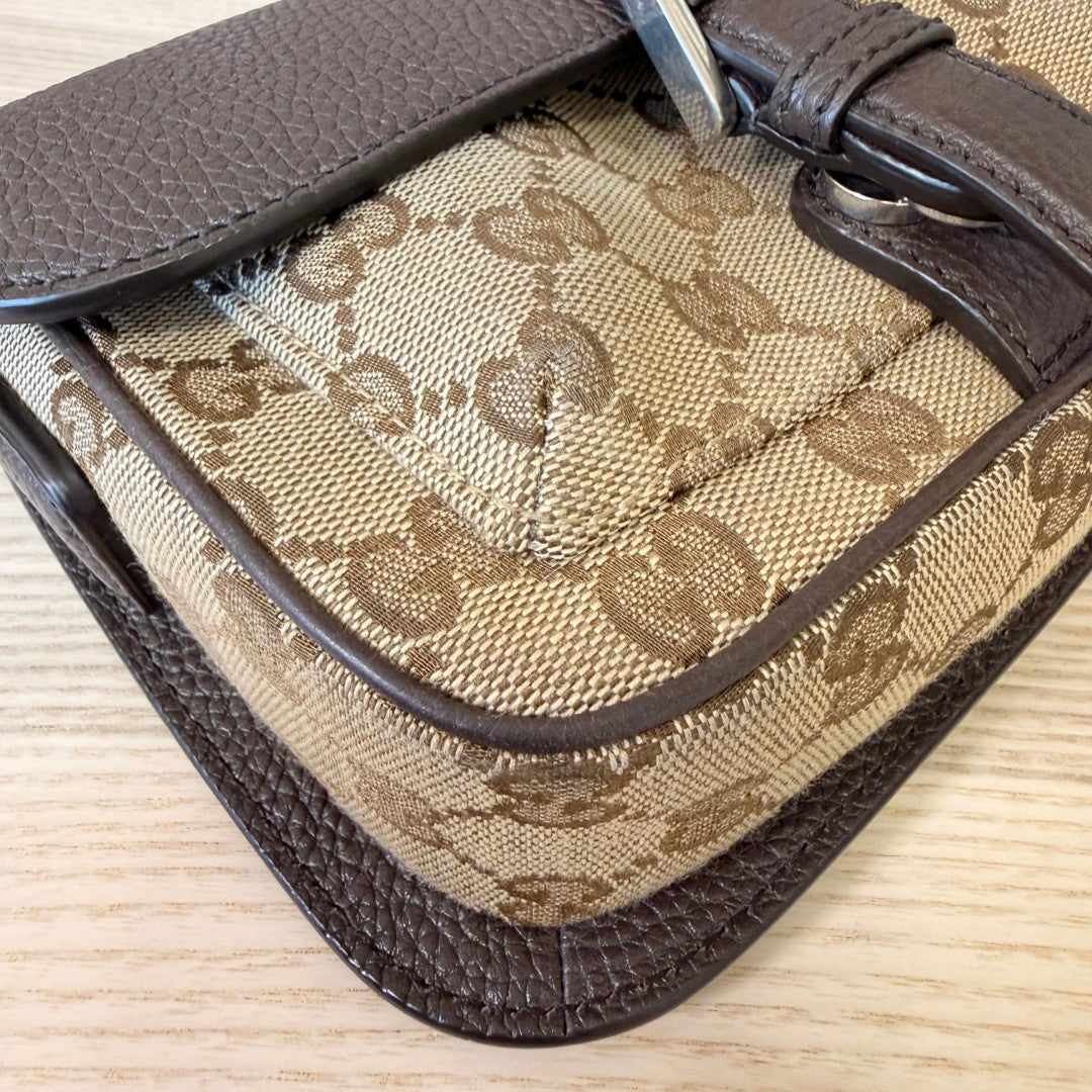 Luxe Vault Gucci monogram mini crossbody bag featuring brown leather trim and classic canvas pattern