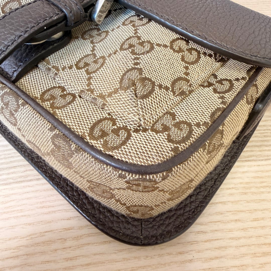 Luxe Vault Gucci monogram canvas mini crossbody bag with brown leather trim and corner detailing