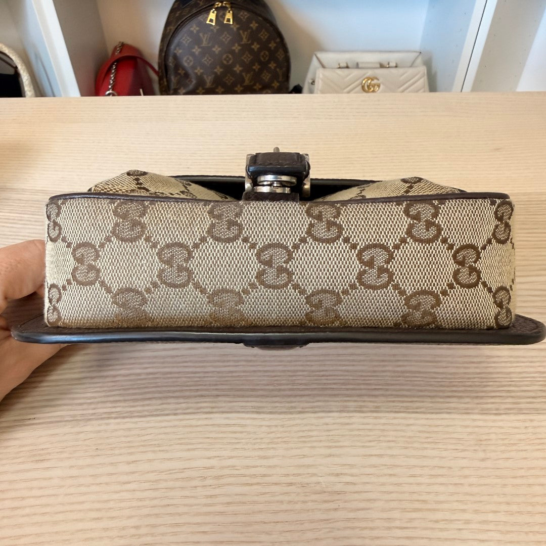 Luxe Vault Gucci monogram canvas mini crossbody bag base view showing brown leather trim and metal hardware