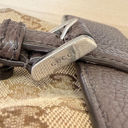 Luxe Vault Gucci monogram canvas crossbody bag featuring brown leather trim and a silver-tone metal logo buckle