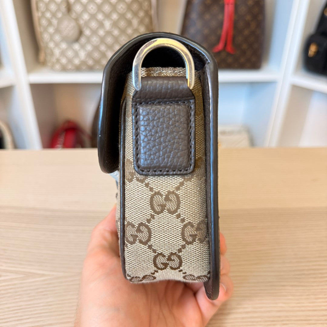 Luxe Vault Gucci monogram mini crossbody bag side view showing brown leather trim and canvas texture