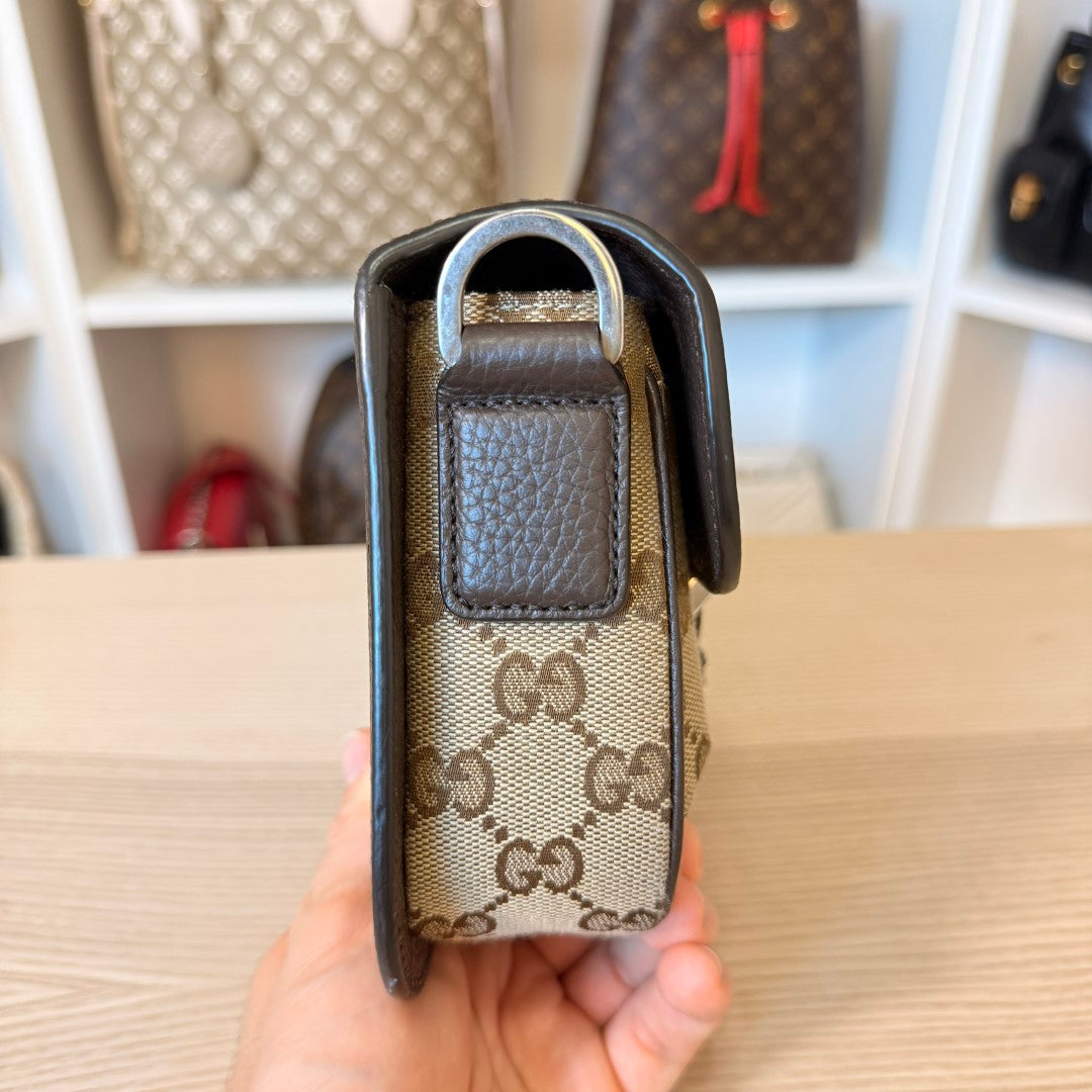 Luxe Vault Gucci monogram canvas mini crossbody bag side view showing brown leather trim and silver hardware