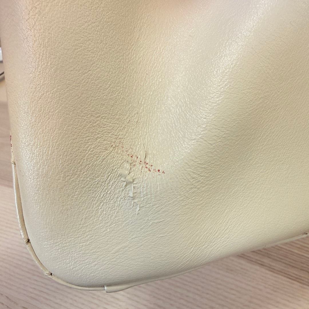 Luxe Vault Gucci white calfskin GG Marmont tote showing a small scratch and mark on the exterior leather surface