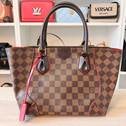 Luxe Vault Louis Vuitton Caissa PM handbag in Damier Ebene canvas with brown leather handles and red trim.