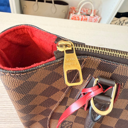 Luxe Vault Louis Vuitton Caissa PM handbag in Damier Ebene canvas with gold hardware and vibrant red interior lining