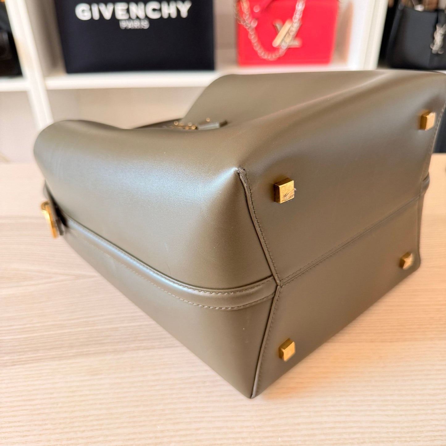 Luxe Vault Saint Laurent Le 37 bucket bag in deep musk shiny calfskin leather showing the base with gold-tone feet