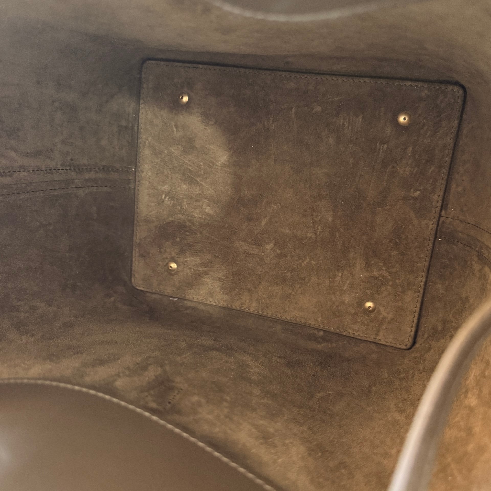 Interior view of Luxe Vault Saint Laurent Le 37 bucket bag in deep musk suede with protective metal feet