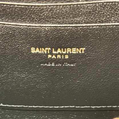 Luxe Vault Saint Laurent Paris gold foil logo embossed on black lambskin leather interior of a camera bag
